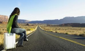 Woman Hitchhiking on Rural Road