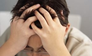 Stressed Schoolboy with Head in Hands